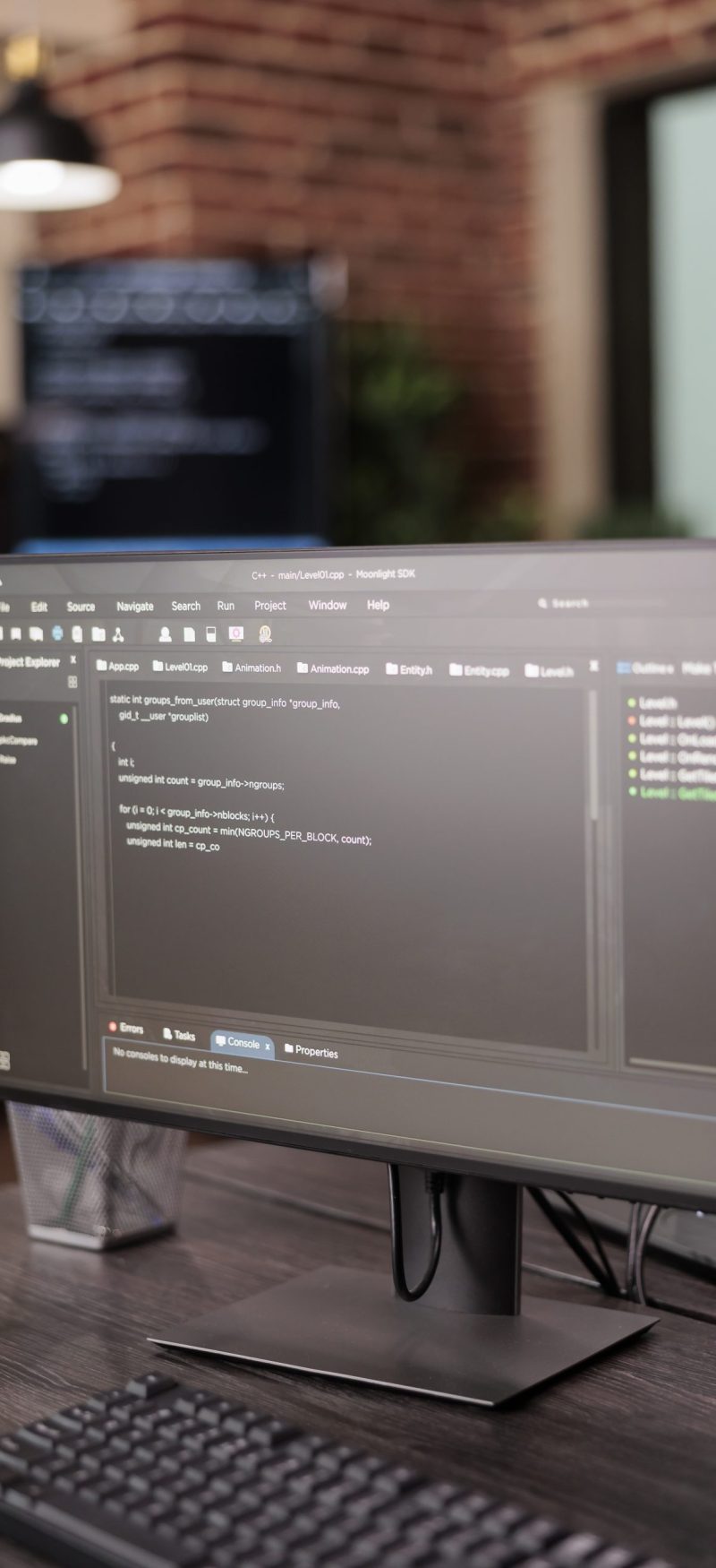 Computer monitors showing source code in empty it company office, security system compiling data algorithms in background. Artificial intelligence servers cloud computing in programming room